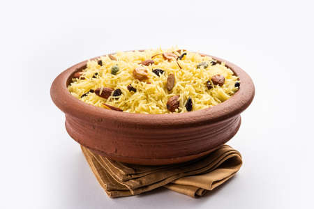 Kashmiri sweet modur pulao made of rice cooked with sugar, water flavored with Saffron and dry fruitsの写真素材