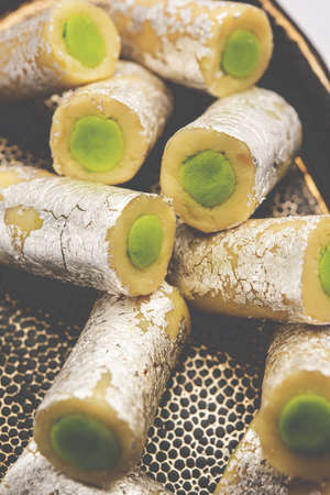 Kaju Pista Roll Or Cashew Pistachio Rolls Mithai or sigar, Indian sweet or dessert for festivalsの写真素材