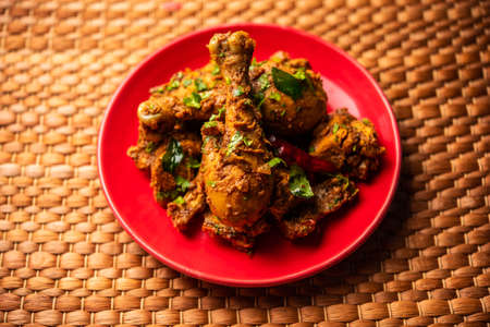 Sukha mutton or chicken, dry spicy Murgh or goat meat served in a plate or bowlの写真素材