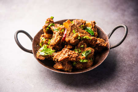 Sukha mutton or chicken, dry spicy Murgh or goat meat served in a plate or bowlの写真素材