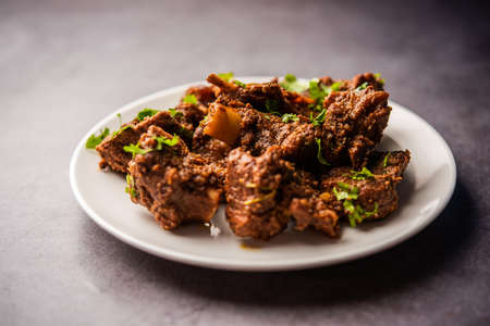 Sukha mutton or chicken, dry spicy Murgh or goat meat served in a plate or bowlの写真素材