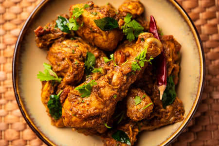 Sukha mutton or chicken, dry spicy Murgh or goat meat served in a plate or bowl