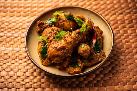 Sukha mutton or chicken, dry spicy Murgh or goat meat served in a plate or bowlの写真素材