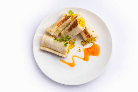 Indian paneer bread roll made using spiced grated cottage cheese mixed with spices & rolled & bakedの写真素材