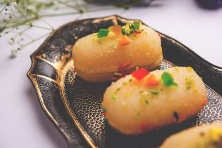 Malai Chop or Cream sandwich made using filling Rasgulla or Gulab jamun sweet is a Bengali sweetの写真素材