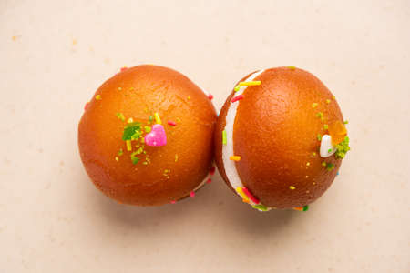 Malai Chop or Cream sandwich made using filling Rasgulla or Gulab jamun sweet is a Bengali sweetの写真素材