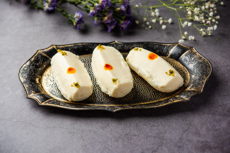Malai Chop or Cream sandwich made using filling Rasgulla or Gulab jamun sweet is a Bengali sweetの写真素材