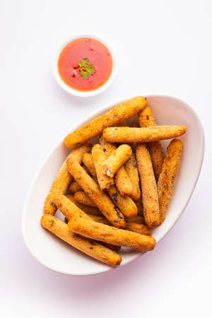 crispy Rava Aloo fingers or Potato semolina fried finger sticks served with ketchup