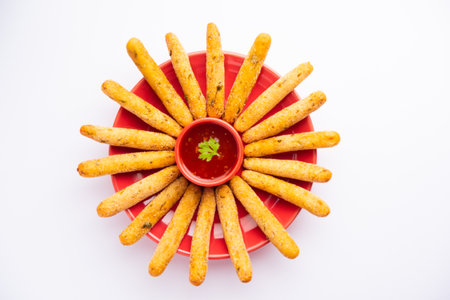 crispy Rava Aloo fingers or Potato semolina fried finger sticks served with ketchup