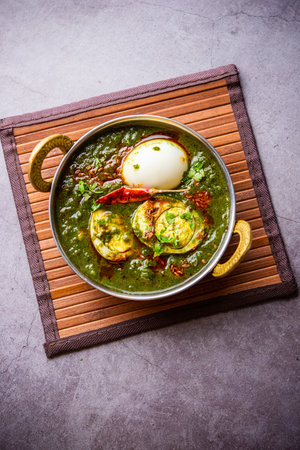 Spinach egg curry is an Indian non vegetarian dish made using palak gravy with eggs
