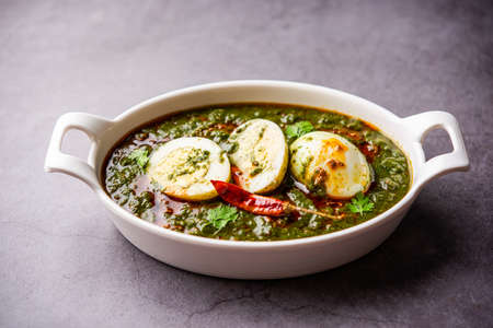 Spinach egg curry is an Indian non vegetarian dish made using palak gravy with eggs