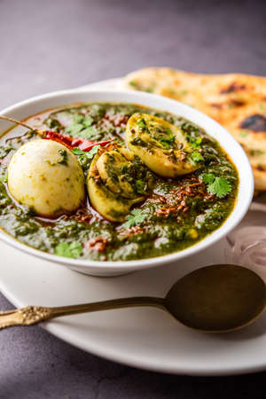 Spinach egg curry is an Indian non vegetarian dish made using palak gravy with eggs
