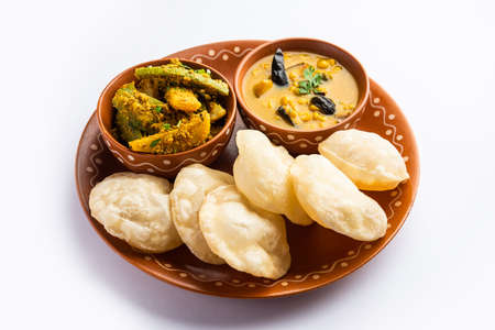 Cholar dal and patol aloo sabzi served with fried Luchi or poori, bengali food