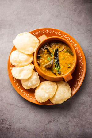 Luchi Cholar Dal or Fried bread made of flour served along with curried Chana or Bengal gram