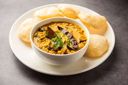 Luchi Cholar Dal or Fried bread made of flour served along with curried Chana or Bengal gramの写真素材
