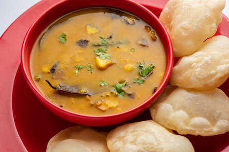 Luchi Cholar Dal or Fried bread made of flour served along with curried Chana or Bengal gram