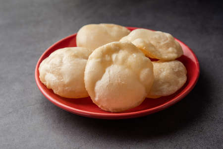 Luchi or Lusi is a deep-fried poori or flatbread, made of Maida flour, originating from Bengal