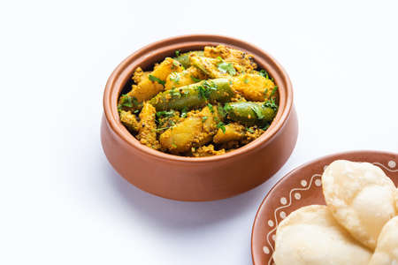 Aloo Patol sabzi made using pointed gourd and potato served with fried Luchi or poori, Bengali food