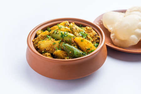 Aloo Patol sabzi made using pointed gourd and potato served with fried Luchi or poori, Bengali food