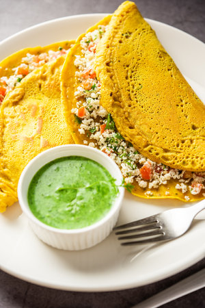 Paneer stuffed Besan chilla or Cheela made using chickpea flour with cottage cheese stuffingの写真素材