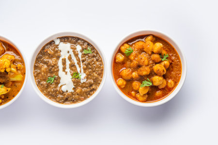 Group of Indian vegetarian dishes, hot and spicy Punjabi cuisine meal assortment in bowlsの写真素材