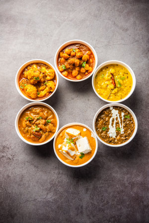 Group of Indian vegetarian dishes, hot and spicy Punjabi cuisine meal assortment in bowlsの写真素材
