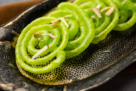 Green Jalebi mithai or sweet from India, a Twist to a traditional imarti or jilbiの写真素材