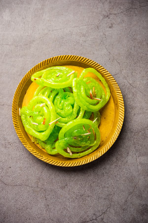 Green Jalebi mithai or sweet from India, a Twist to a traditional imarti or jilbiの写真素材