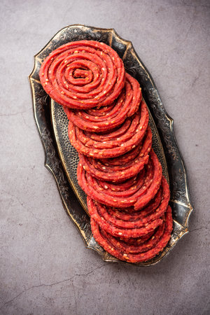 Beatroot chakli, murukku, Beetroot chakli, a spiral fried snack from India made in Diwali festival