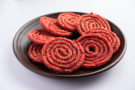 Beatroot chakli, murukku, Beetroot chakli, a spiral fried snack from India made in Diwali festivalの写真素材