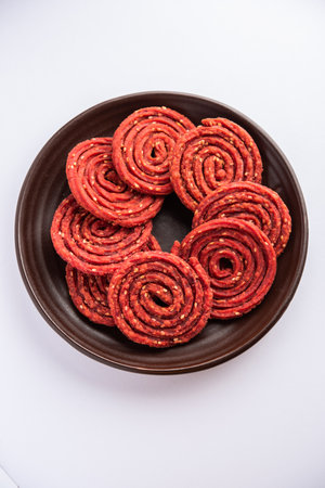 Beatroot chakli, murukku, Beetroot chakli, a spiral fried snack from India made in Diwali festivalの写真素材