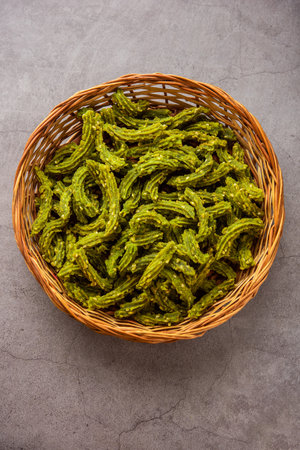 Palak Chakli sticks or Spinach Murukku pieces, healthy Indian festival or tea time snackの写真素材