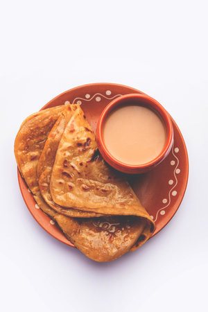 Chai Paratha - Hot Tea served with Flatbread is a traditional simple meal from India and Pakistanの写真素材