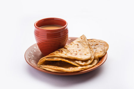 Chai Paratha - Hot Tea served with Flatbread is a traditional simple meal from India and Pakistanの写真素材