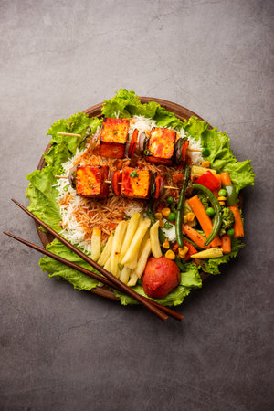 Paneer Sizzler is an Indian version with cottage cheese, salad served sizzling on hot stone dish.の写真素材