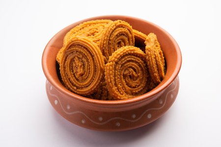 Chakli is a savoury snack from India. It is a spiral shaped snack with a spiked surfaceの写真素材