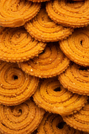 Chakli is a savoury snack from India. It is a spiral shaped snack with a spiked surfaceの写真素材