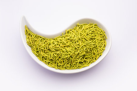 palak sev is a crispy crunchy green colored spinach flavored fried farsan with salt, spice powderの写真素材