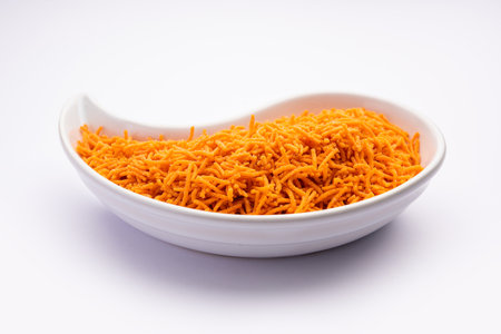 Tomato sev is a crispy crunchy orange colored flavored fried farsan with salt and spice powders