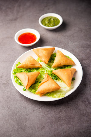 cocktail mini triangle samosa made using patti or strip, popular home made snack from India