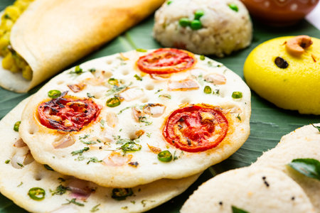 South Indian Masala Dosa, Uttapam, Idli vada sambar, semolina halwa, upma served over banana leaf