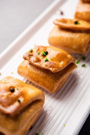 Lavang Latika: traditional Indian sweet. Crescent shape, deep-fried, soaked in sugar syrup. Served...