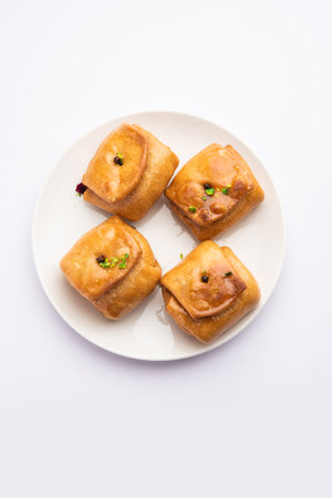 Lavang Latika: traditional Indian sweet. Crescent shape, deep-fried, soaked in sugar syrup. Served during festivals.の写真素材