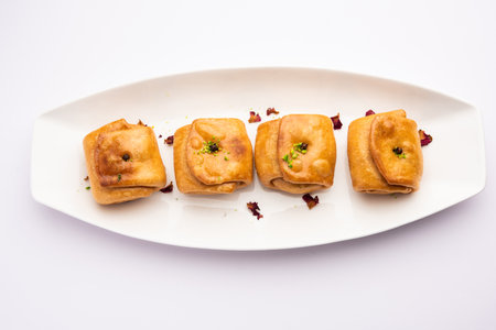 Lavang Latika: traditional Indian sweet. Crescent shape, deep-fried, soaked in sugar syrup. Served...