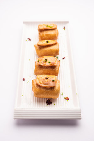 Lavang Latika: traditional Indian sweet. Crescent shape, deep-fried, soaked in sugar syrup. Served...