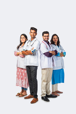 Indian asian young Team of doctor or medical professionals standing with arms crossed against white backgroundの写真素材