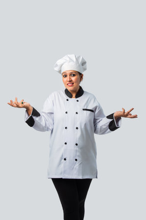 Indian asian Female Chef Giving Thumbs Up celebrating success - Professional Cook in Uniformの写真素材