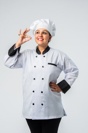 Indian asian Female Chef Giving Thumbs Up celebrating success - Professional Cook in Uniformの写真素材