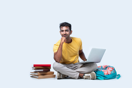 Indian asian male college student studying while sitting isolated on white background