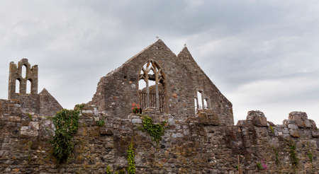 Old gray stone ruins in cloudy weatherの写真素材